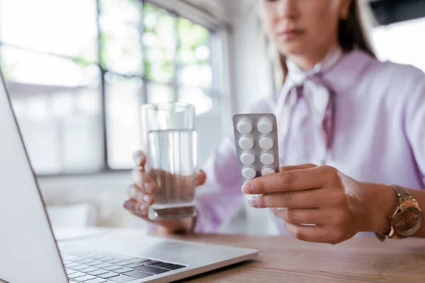 Cropped View Woman Holding Glass Water Blister Pack Pills Laptop — Stock Photo, Image