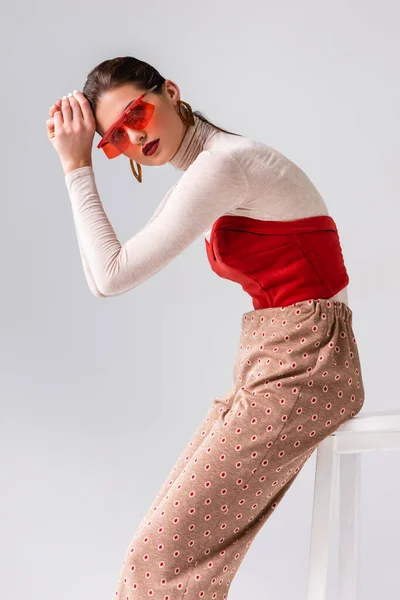 Fashionable Girl Looking Camera Holding Hands Head While Sitting Stool — Stock Photo, Image