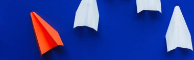 top view of white and red paper planes on blue background, leadership concept, panoramic shot clipart