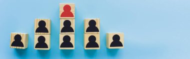 panoramic shot of wooden blocks with black and red human icons on blue background, leadership and career ladder concept clipart