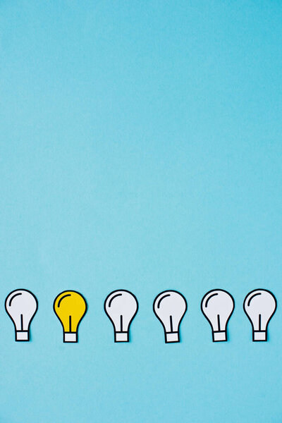 flat lay with paper light bulbs on blue background, business concept