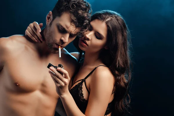 Sexy Woman Bra Holding Lighter Embracing Boyfriend Cigarette Black Background — Stock Photo, Image