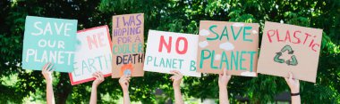 Panoramic shot of people holding placards with save our planet and one earth lettering outdoors, ecology concept clipart
