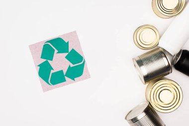 Top view of card with recycle symbol near tin cans on white background, ecology concept clipart