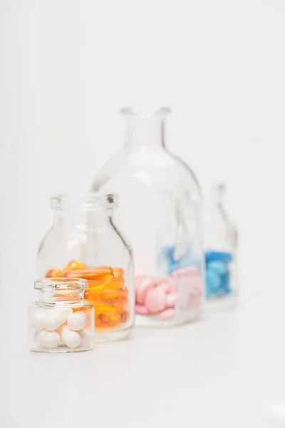 白い背景のガラス瓶の中の薬の選択的焦点 — ストック写真
