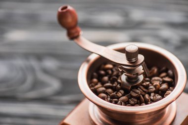 close up view of vintage coffee grinder with coffee beans clipart