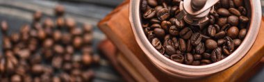 close up view of vintage coffee grinder with coffee beans, panoramic shot clipart