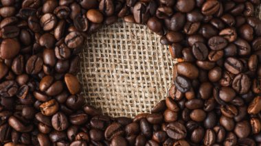 round frame of coffee beans on burlap clipart