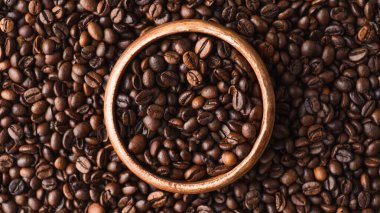top view of coffee beans in wooden bowl clipart