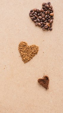 top view of hearts made of coffee on beige surface clipart