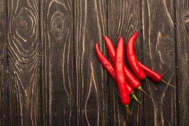 top view of chili peppers on wooden surface clipart
