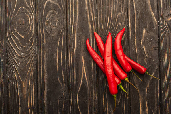 top view of chili peppers on wooden surface