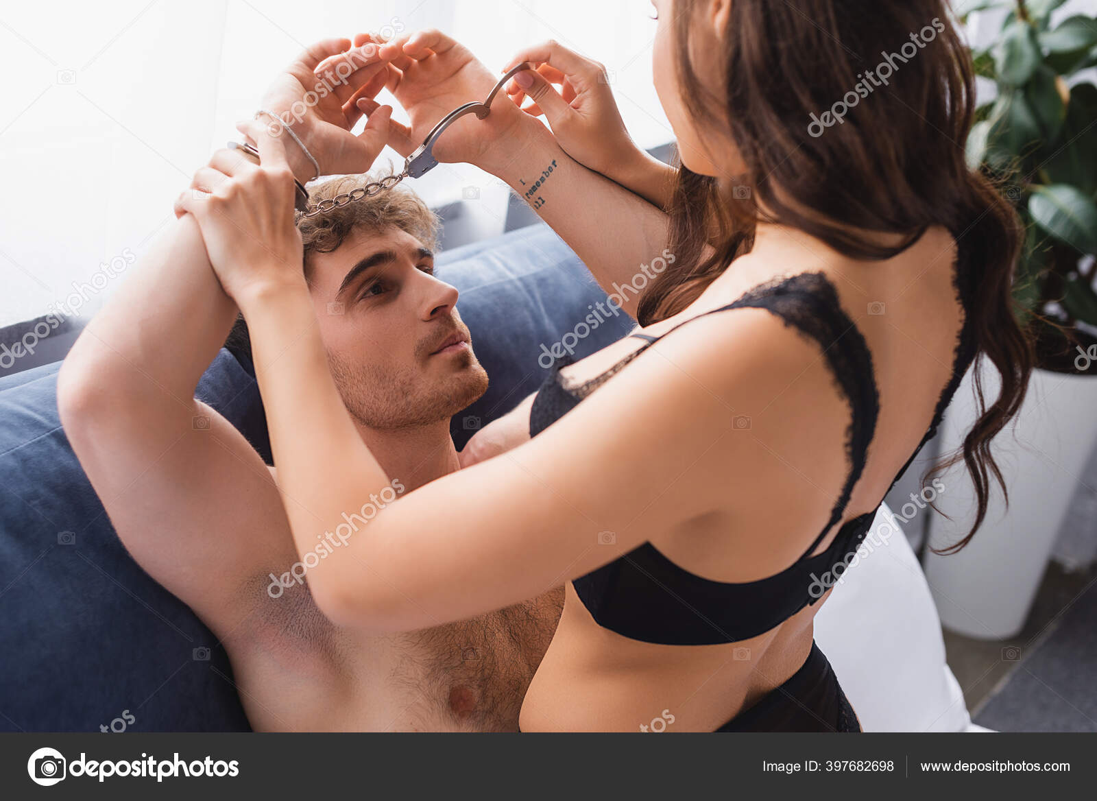 Dominant Woman Touching Handcuffed Tattooed Man Bedroom Stock Photo by ©VitalikRadko 397682698