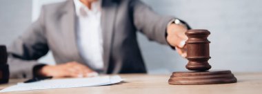 panoramic shot of judge holding gavel near stethoscope and documents  clipart