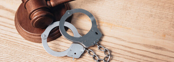 заголовок сайта молотка возле наручников на деревянном столе