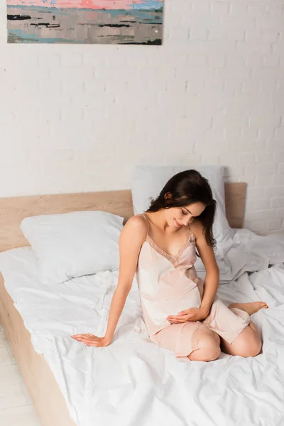 Pregnant Brunette Woman Silk Nightie Sitting Bed Touching Belly — Stock Photo, Image