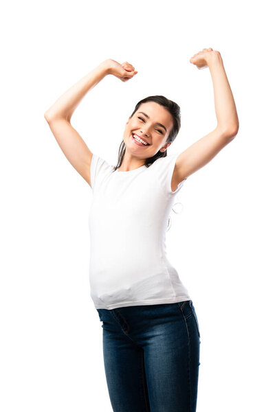 young pregnant woman in white t-shirt standing with hands above head isolated on white 