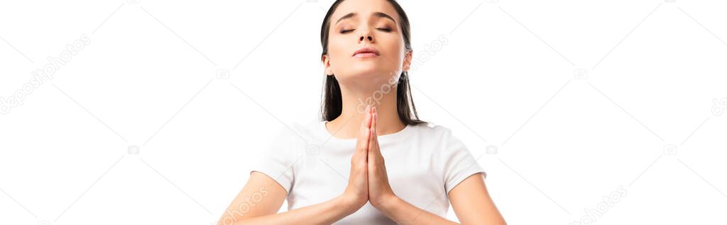panoramic shot of woman with closed eyes and praying hands isolated on white 