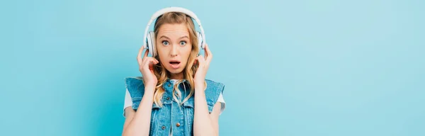 Panoramic Concept Shocked Woman Denim Vest Touching Wireless Headphones While — Stock Photo, Image