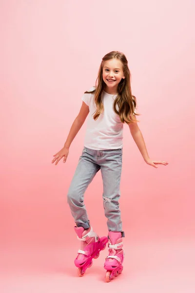 Excited Girl White Shirt Jeans Rolling Skates Looking Camera Pink — Stock Photo, Image