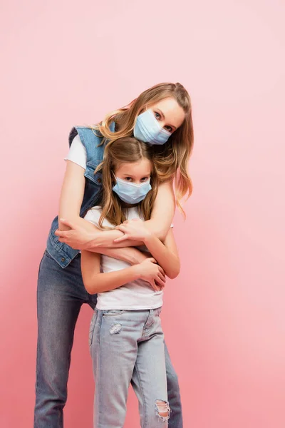 Young Woman Child Medical Masks Hugging Looking Camera Isolated Pink — Stock Photo, Image