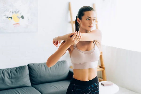 Young Brunette Sportswoman Stretching Arms Home — Stock Photo, Image