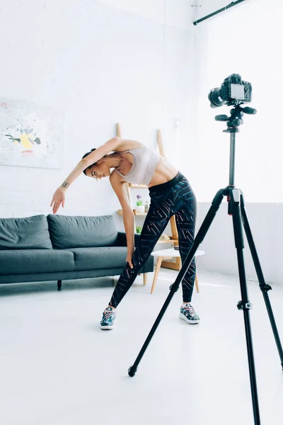 Selective Focus Young Sportswoman Stretching Digital Camera Living Room — Stock Photo, Image