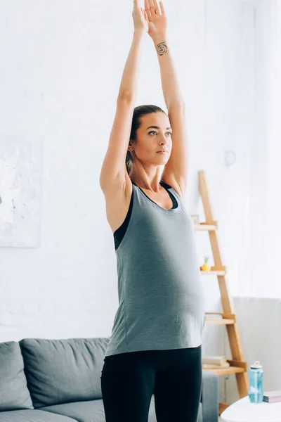 Pregnant Sportswoman Looking Away While Exercising Home — Stock Photo, Image