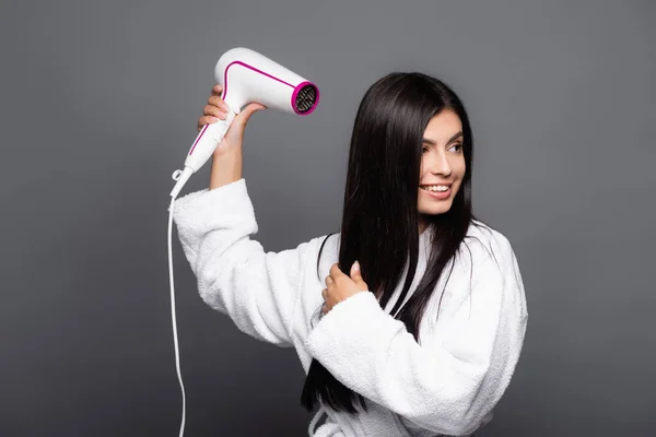 Brunette Long Haired Woman Bathrobe Using Hairdryer Isolated Black — Stock Photo, Image