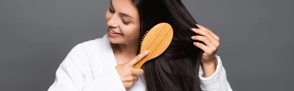 Brunette Woman Bathrobe Brushing Hair Smiling Isolated Black Panoramic Shot — Stock Photo, Image