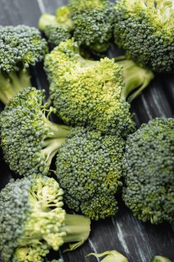 close up view of fresh green broccoli on wooden surface clipart