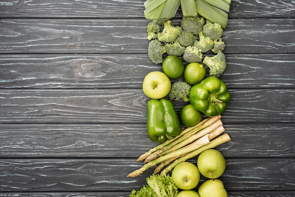 top view of fresh green fruits and vegetables on wooden surface