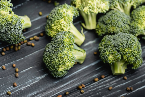 close up view of fresh green broccoli on wooden surface