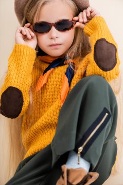 Sonbahar kıyafetleri ve güneş gözlükleriyle şık sarışın kız.