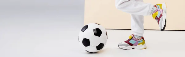 Cropped View Girl Sneakers Posing Soccer Ball Beige White Background — Stock Photo, Image