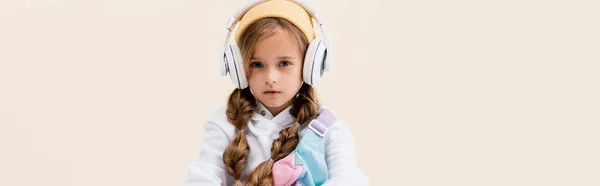 Blonde Girl Sportswear Headphones Isolated Beige Panoramic Shot — Stock Photo, Image