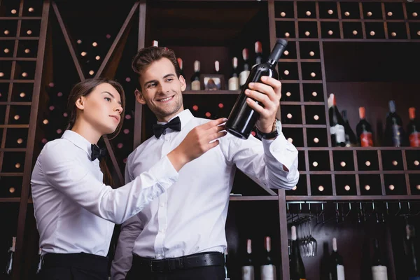 Young Sommelier Holding Bottle Wine Colleague Racks Restaurant — Stock Photo, Image