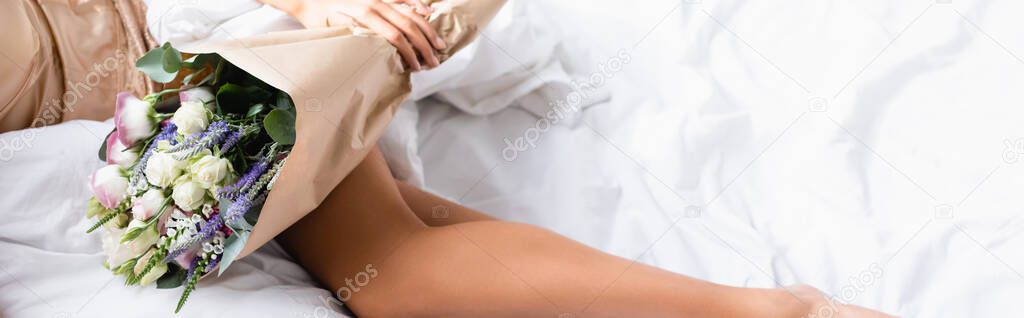 Panoramic crop of woman lying on bed and holding bouquet of flowers — Stock Image Panoramic Crop Woman Lying Bed Holding Bouquet Flowers Stock Picture