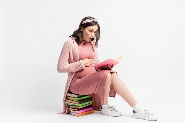 Shocked Pregnant Woman Sitting Books Touching Belly White — Stock Photo, Image