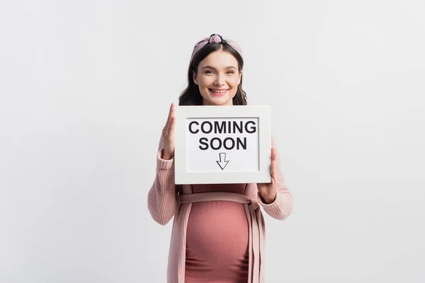 Joyful Pregnant Woman Holding Board Coming Soon Lettering Isolated White — Stock Photo, Image