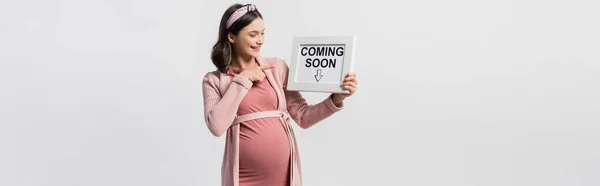 Joyful Pregnant Woman Pointing Finger Board Coming Soon Lettering Isolated — Stock Photo, Image