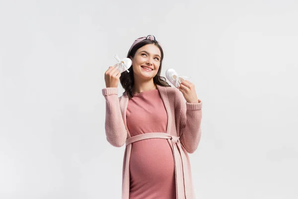 Joyful Pregnant Woman Holding Tiny Boots Looking Isolated White — Stock Photo, Image