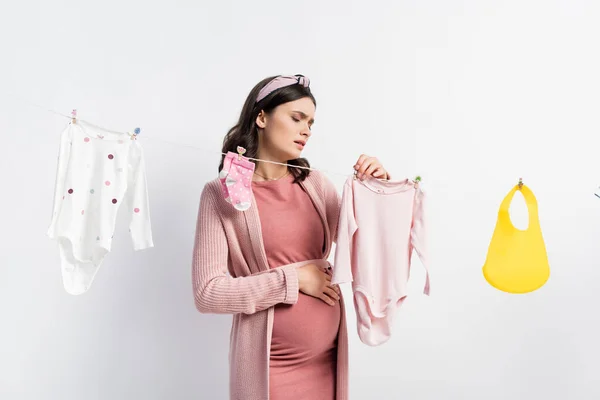 Sad Pregnant Woman Hanging Baby Clothes Clothing Line White — Stock Photo, Image