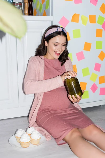 Selective Focus Joyful Woman Holding Jar Canned Cucumbers While Sitting — Stock Photo, Image