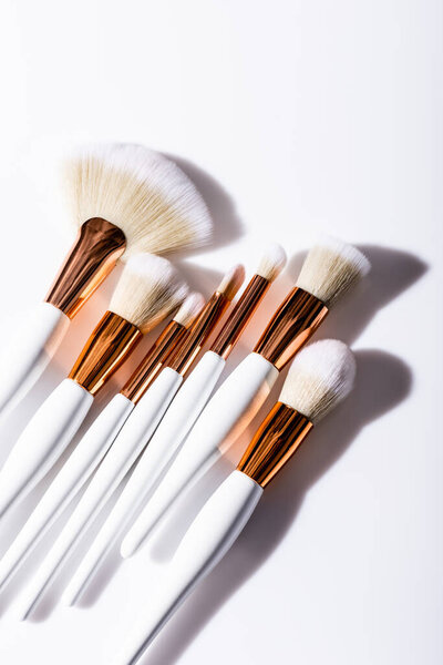top view of cosmetic brushes set on white background