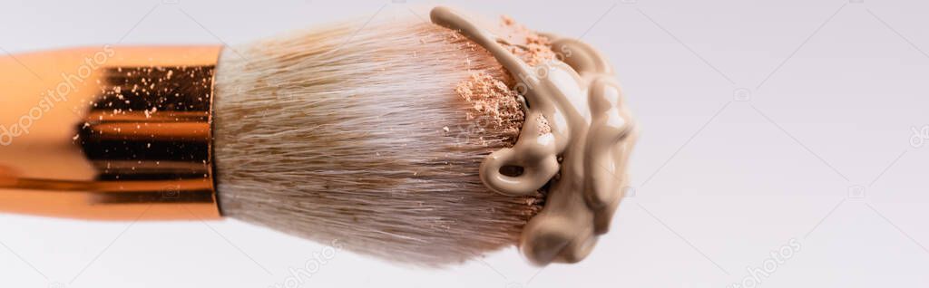 close up view of cosmetic brush with face powder and foundation isolated on white, panoramic shot