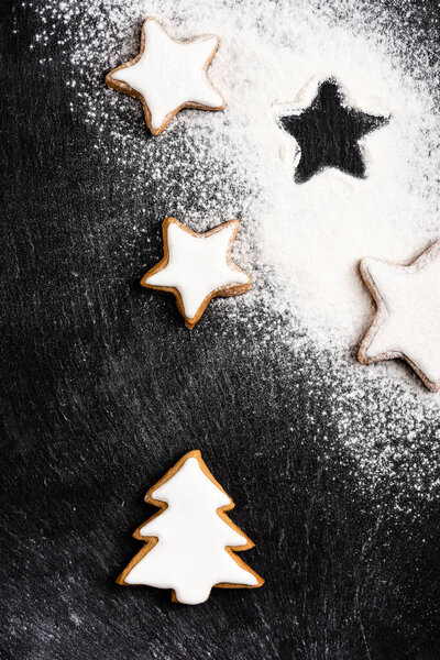 Top view of christmas gingerbread cookies covered with sugar powder 