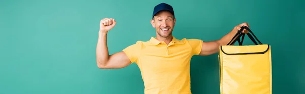 Excited Delivery Man Carrying Yellow Backpack Blue Banner — Stock Photo, Image