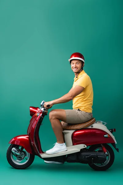 ハッピーデリバリーマンでヘルメットに乗ってバイクに乗って青 — ストック写真