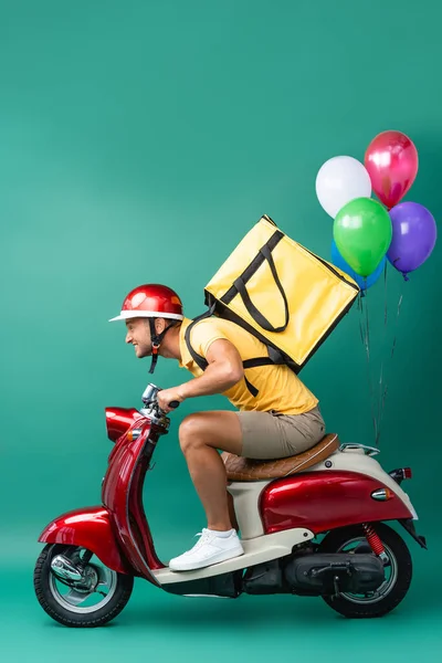 Side View Focused Delivery Man Backpack Riding Scooter Balloons Blue — Stock Photo, Image